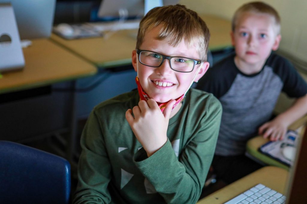 Elementary student smiling in a computer lab