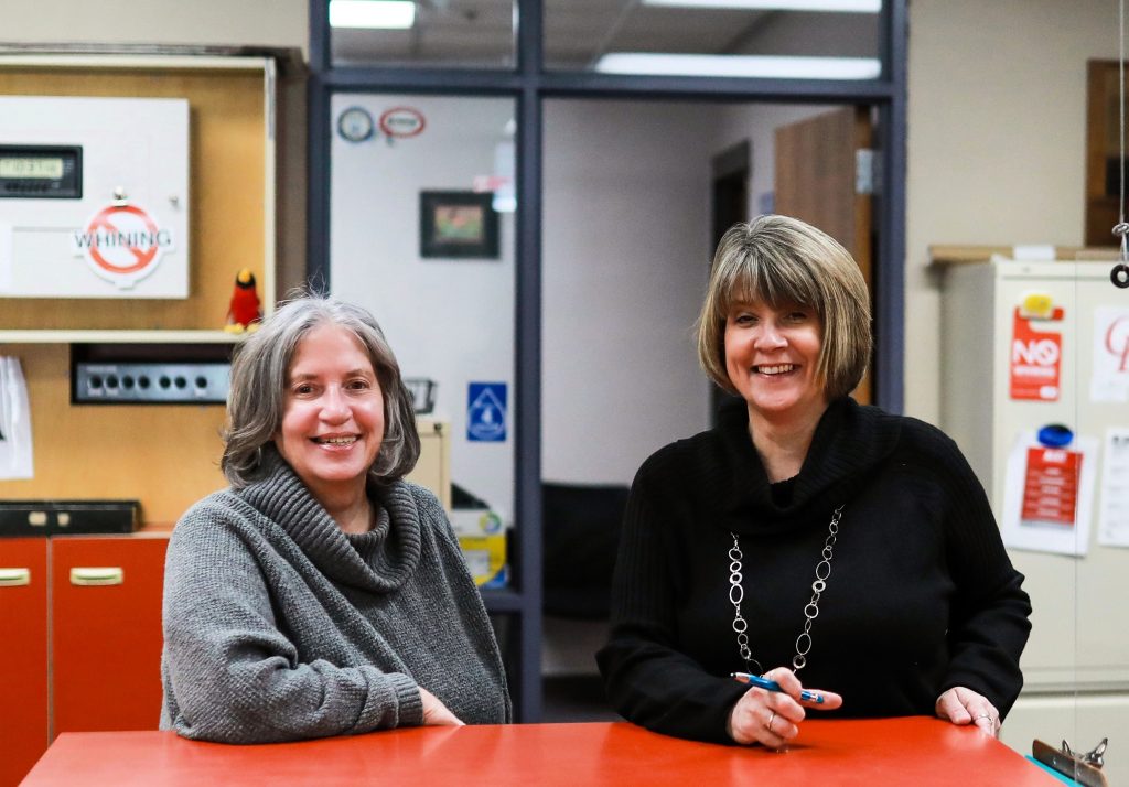 High school office staff welcome visitors