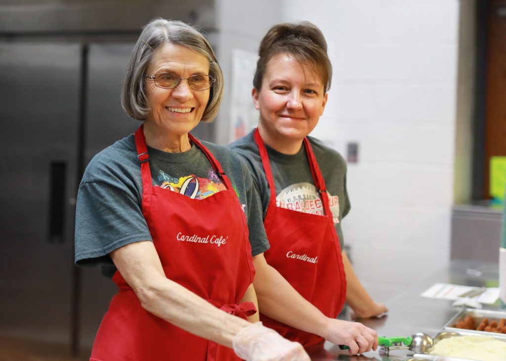 Nutrition workers prepare to serve lunch.