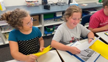 Two fourth grade students working together on their rocket math practice.