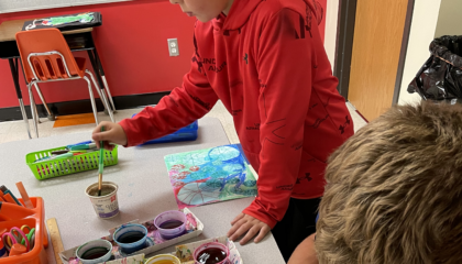 2nd grade art students use painted dots to create artwork