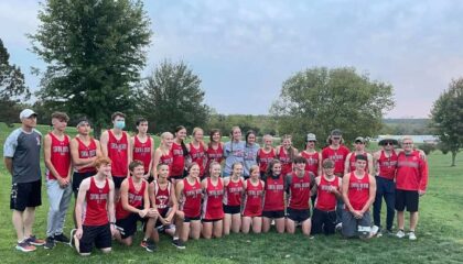 The entire boys and girls cross country teams pose after winning the POI championship