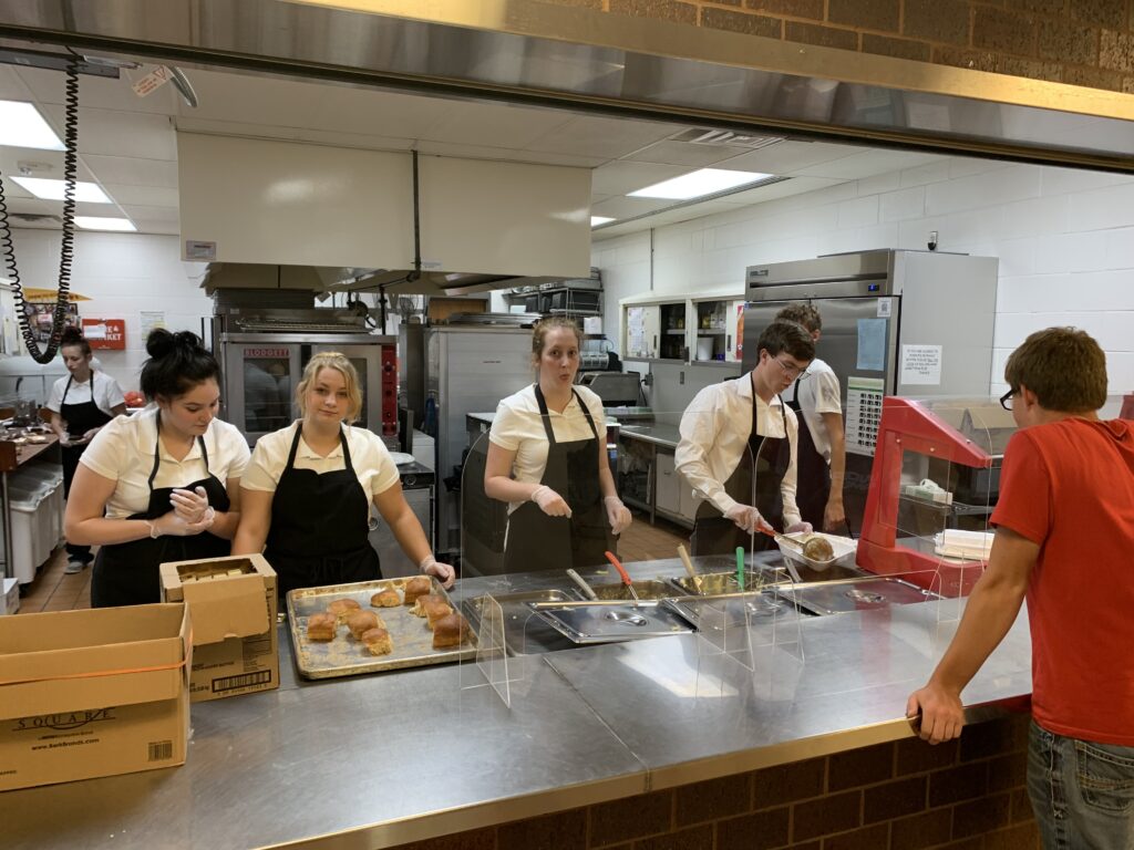 advanced culinary arts students prepare to serve the all music night meal