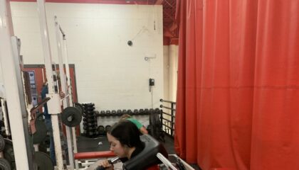 a strength and conditioning student uses a weight machine in a single leg workout