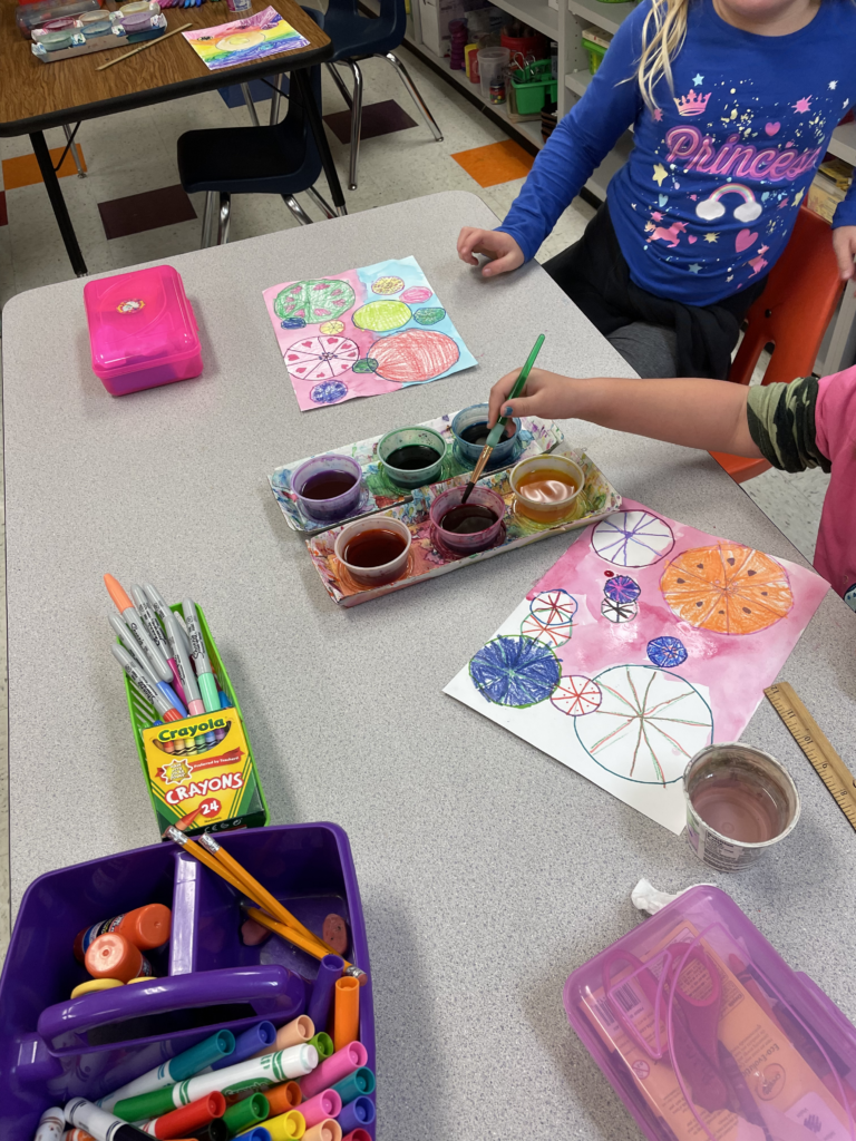 second grade art students paint dots