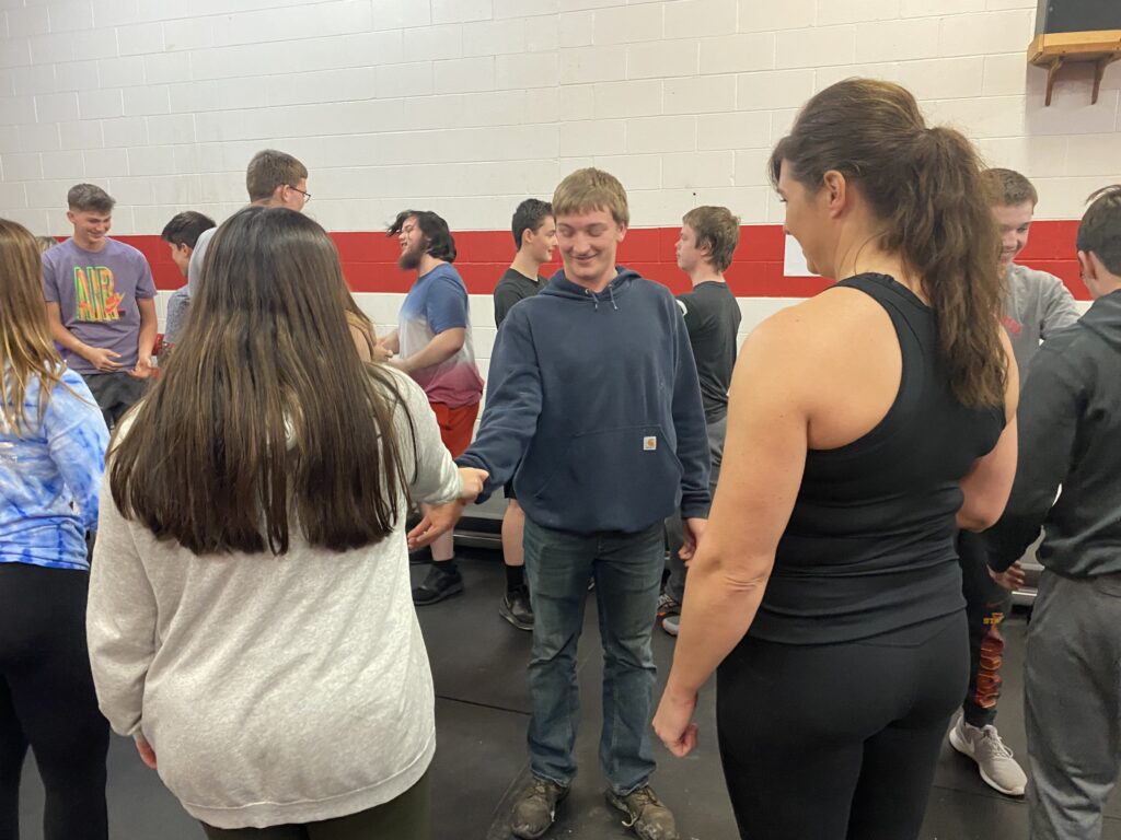 High school PE class learns self defense techniques from CD alum Stacy (Andrew) Purdom.