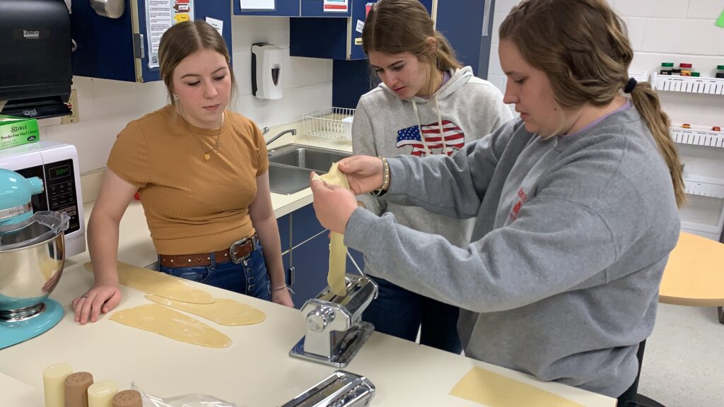 three Culinary arts students prepare dough for freshpasta