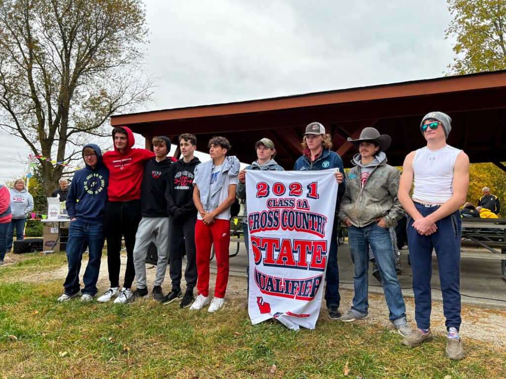 Boys Cross Country Team poses with state qualifying banner