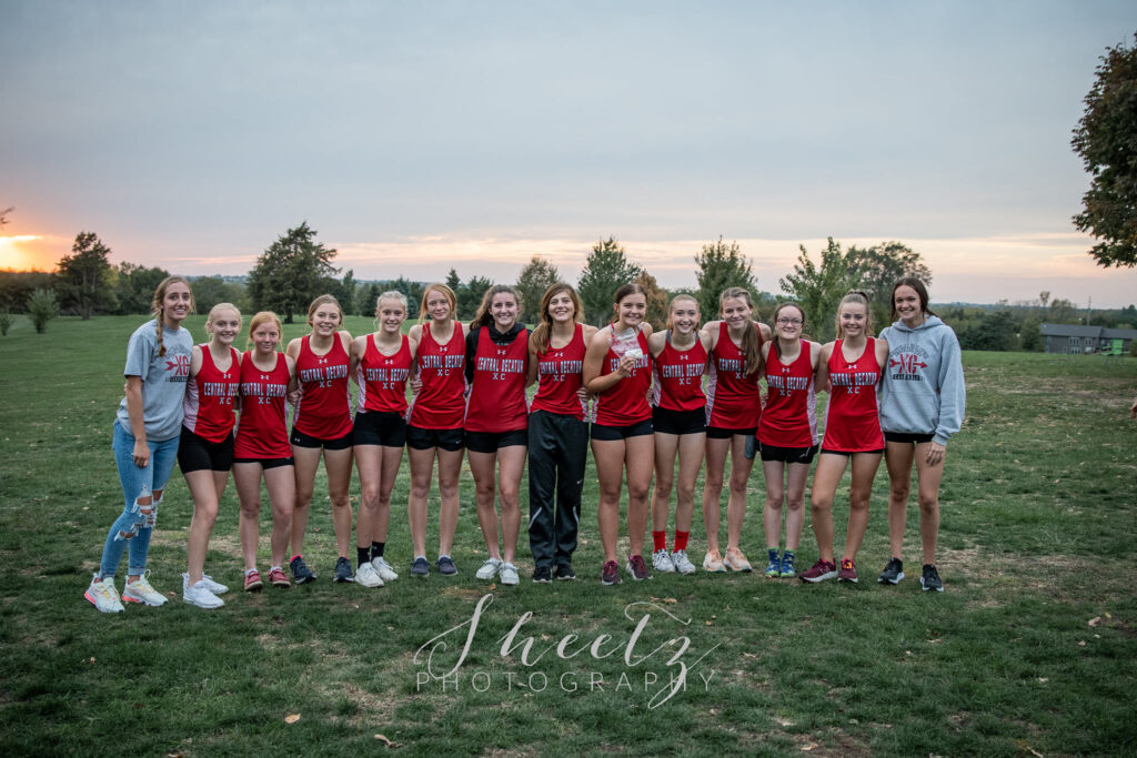 Girls Cross Country team poses with State qualifying medals